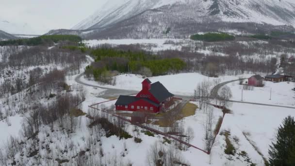 ノルウェーのオールダーデンにある赤い教会 曇りの冬の天気 教会の周りでゆっくりと横に回転する動きで撮影された空中ドローン — ストック動画