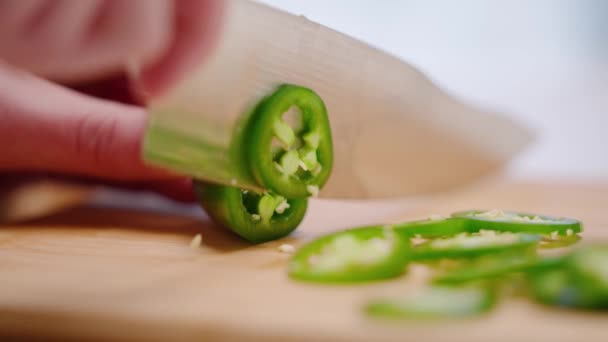 Caucasian Hand Slicing Green Jalapeo Peppers Cutting Board Slow Motion — стоковое видео