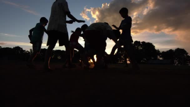 Silhouette Indigenous Children Playing Soccer Golden Sunset Pitch Amazon Rainforest — Stockvideo