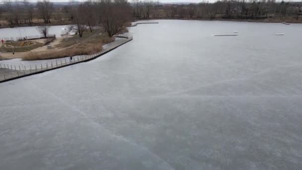 Flight Frozen Lake Breaking Ice Rural Village Poland Aerial Videography — Stockvideo