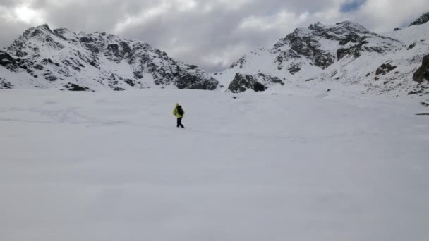 Aerial Side View Alpinist Advancing Snowy Mountains Clowdy Day European — Stockvideo