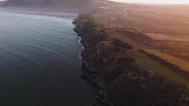 Aerial Dolly Cliff Face Coastline Hazy Sunrise Rhossili Gower Drone — Stock Video