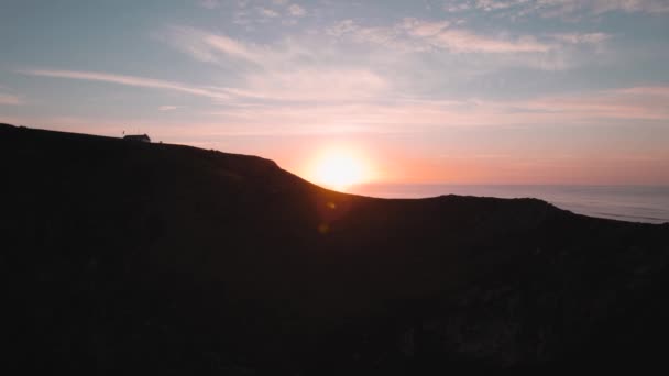 Aerial Sideways Dolly Revealing Coastgaurd Lookout Orange Sunrise Rhossili Gower — Stockvideo