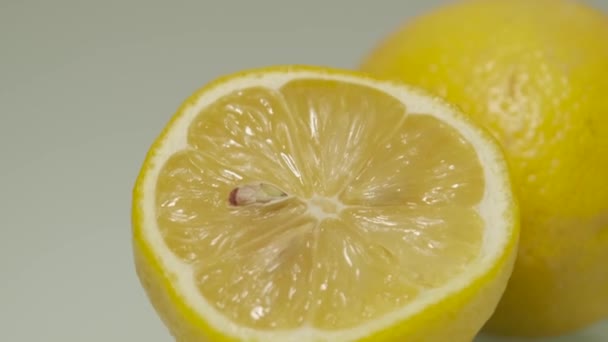 Juicy Fresh Cut Lemon Yellow Peel White Rind Panning Right — Stockvideo