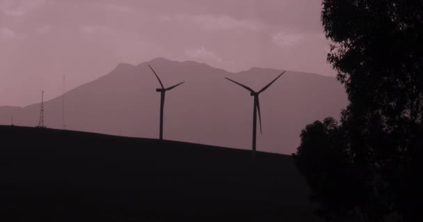 Silhouetted Turning Wind Turbines Cloudy Moody Sky — Stock video