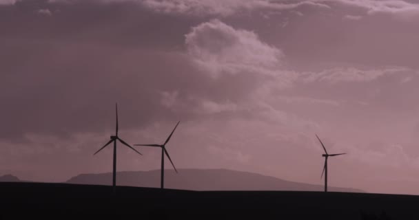 Silhouetted Turning Wind Turbines Cloudy Moody Sky — Stock video