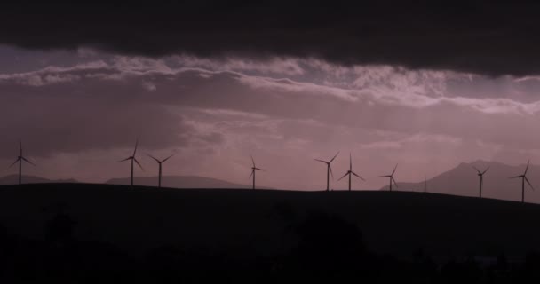 Silhouetted Turning Wind Turbines Cloudy Moody Sky — 비디오