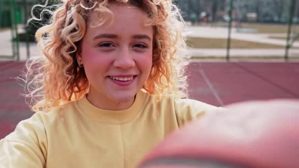 Caucasian Teenaged Girl Holding Basketball Looking Camera Winking Slow Motion — Vídeos de Stock