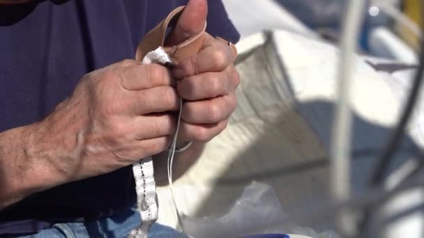 Man Sewing Repairing Sail — стоковое видео