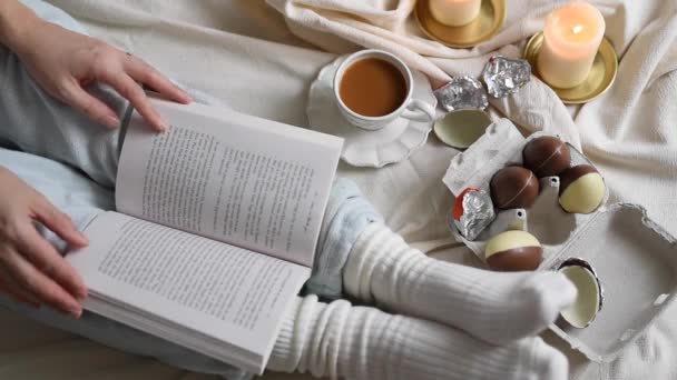 View Hands Reading While Turning Pages Coffee Chocolate Easter Eggs — Wideo stockowe