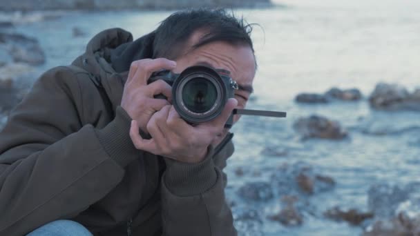 Young Nepali Man Looking Camera Viewfinder Rocky Coastline — Stockvideo