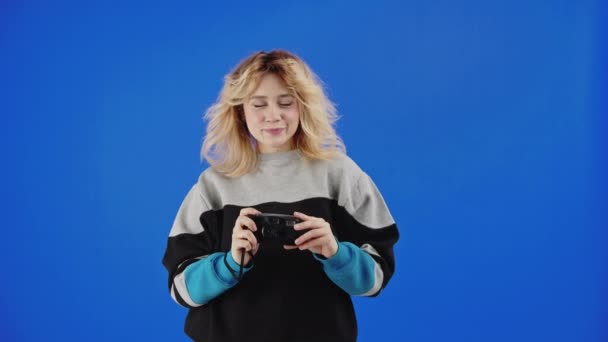 Teenage Caucasian Blonde Girl Taking Picture Film Camera Blue Screen — Stock video