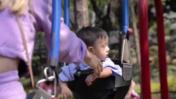 Cute Latin Baby Boy His Mother Playing Swings Park Playground — Vídeo de stock