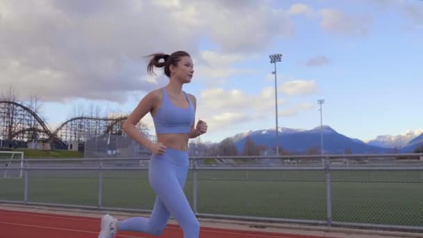 Mixed Race Woman Running Track Empty Field Blue Hour Slow — стокове відео