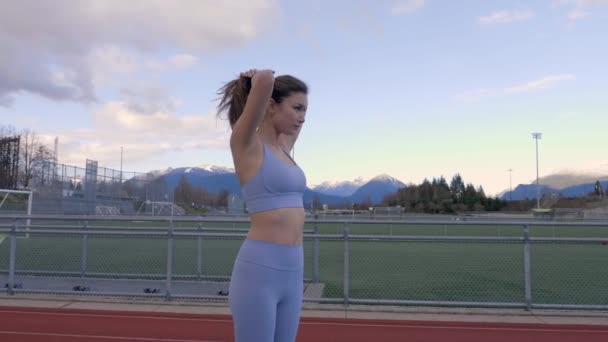 Athletic Young Woman Pulling Hair Back Bun Track Field — Vídeo de Stock