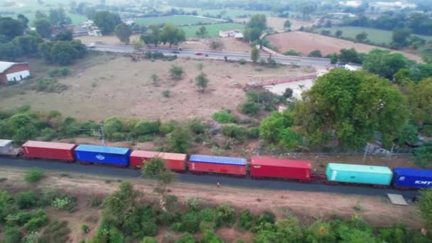 Aerial Rotating Drone View Freight Train Red Blue Coloured Carriages — Vídeos de Stock