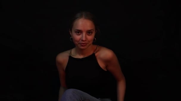 Confident Teenage Girl Flirting While Sitting Front Black Background — Stock video