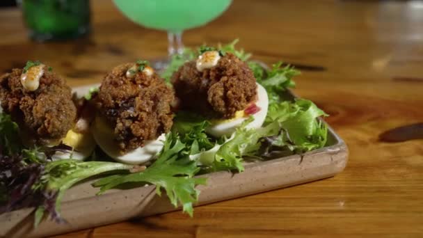 Fried Oyster Topped Deviled Eggs Plated Field Greens Rustic Stoneware — Stock Video