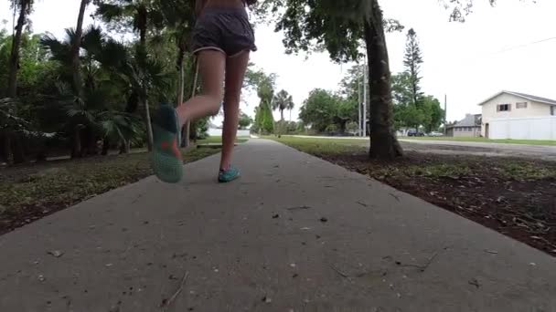 Young Teenage Girl Running Sidewalk — стоковое видео