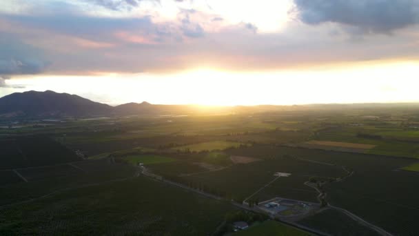 Aerial Dolly Green Farm Fields Trees Surrounded Mountains Cloudy Bright — Videoclip de stoc