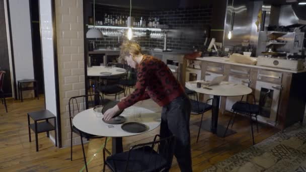 Slomo Ung Kvinna Flyttar Tallrikar Från Runda Restaurang Bord — Stockvideo