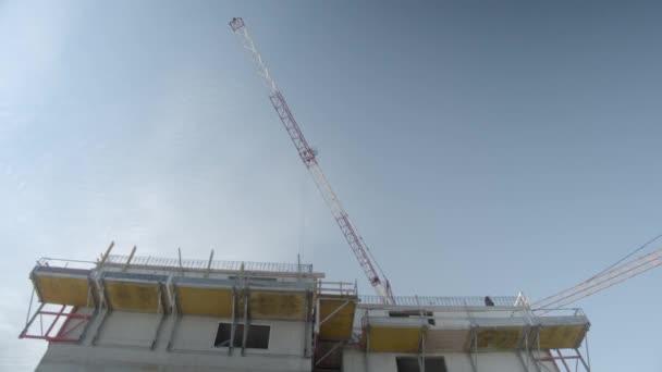 Low Angle View Tower Cranes Work Building Construction Site Pan — Vídeo de Stock