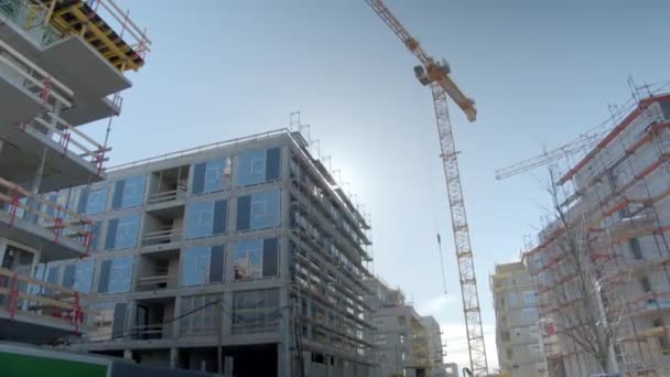 Tall Tower Crane Construction Site Modern Buildings Low Angle — Stockvideo