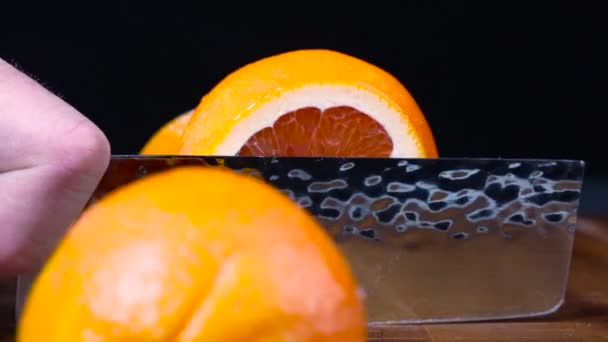 Sharp Kitchen Knife Slicing Juicy Vibrant Blood Orange Half — Stockvideo