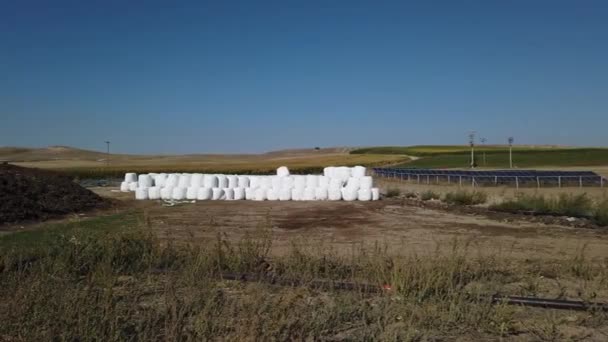 Wrapped Stacked Bales Hay Solar Panels — стоковое видео