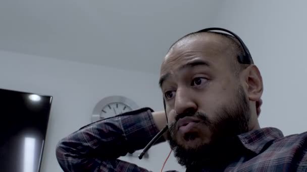 Bald Bearded Ethnic Minority Male Wearing Headset Stroking Back Head — Video Stock