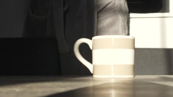 Man Wearing Bathroom Pulls Chair Sit Table Drink Morning Coffee — Wideo stockowe
