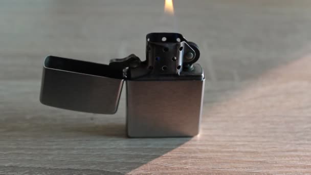 Silver Metal Lighter Orange Flame Burning While Standing Interior Table — Stok video