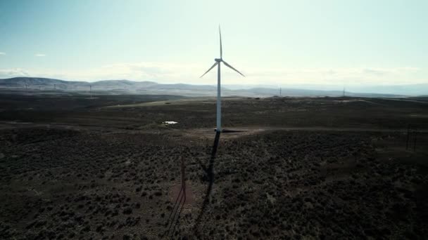 Static Aerial Single Wind Turbine Spinning High Desert Long Shadow — Video Stock