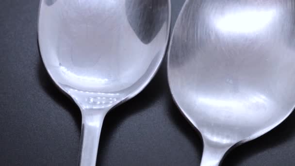 Close View Two Steel Spoons Black Bacground Rotating Motion Close — Videoclip de stoc