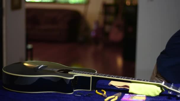 Restringing Cleaning Beautiful Black Single Cutaway Accoustic Guitar Tidying Away — Vídeo de stock