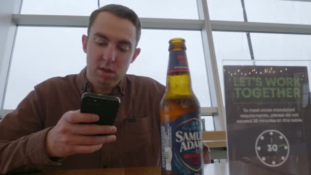 Caucasian Man Checks Mobile Phone While Having Beer Bar Seattle — Stock videók