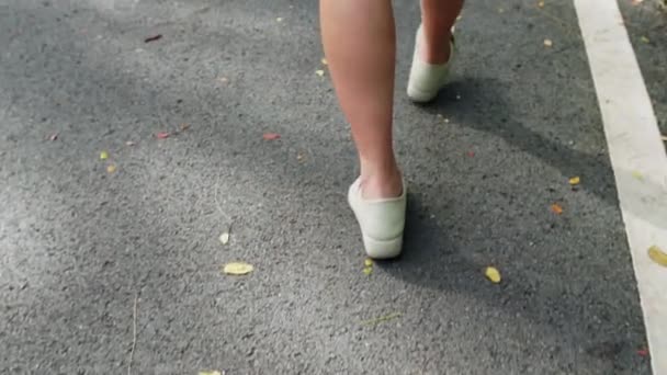 Woman Walking Cobbled Street Close Woman Legs White Shoes Back — Stock videók