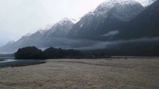 Drone Flying Grassland Beautiful Valley Mountains White Peaks While Snowing — Video Stock