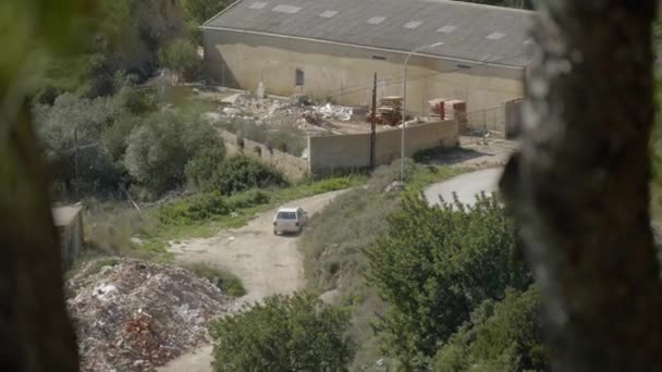 Old White Car Leaves Abandoned Junk Yard Dirt Road — Wideo stockowe