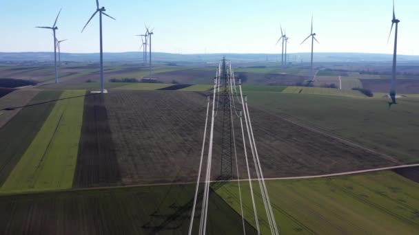 Overhead Power Line Transmission Tower Wind Farm Wind Turbines Aerial — Stockvideo