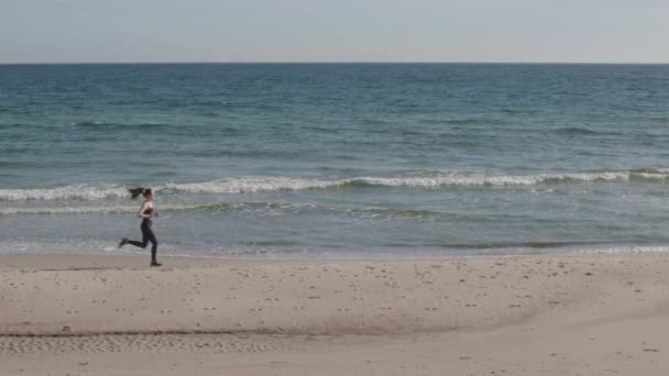 Young Fitness Female Jogging Beach Green Ocean Blue Sky Horizon — Stockvideo