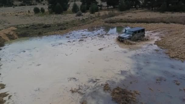 Offroad Car Crossing Water Puddle Drone View — Stock video