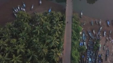Kilakaral canoe boats line narrow river in tropical Goa, India