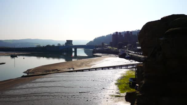 Overlooking Conwy Castle Low Tide Shimmering Sandy Seaside Waterfront Hazy — Stockvideo