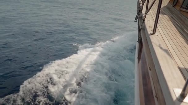 Slow Motion Beautiful Wooden Sailboat Produces Bow Wake Blue Water — Stockvideo