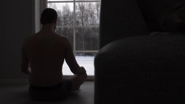 Young Man Meditation Window Snowy Winter Weather Health Relaxation — Stock Video