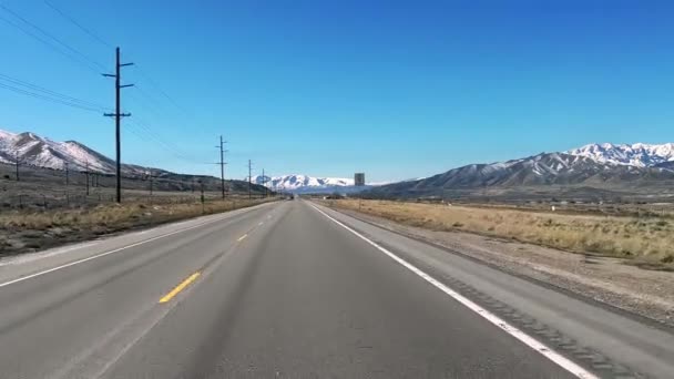 Driving One Lane Highway Snow Capped Mountains — Wideo stockowe