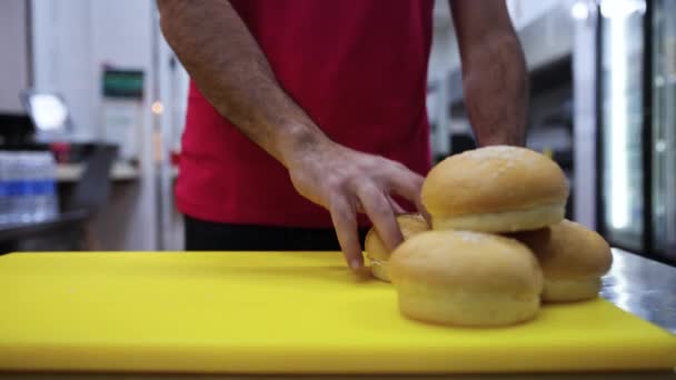 Unrecognizable Man Red Shirt Grabs Burger Bun Sandwich Yellow Cutting — Stok video