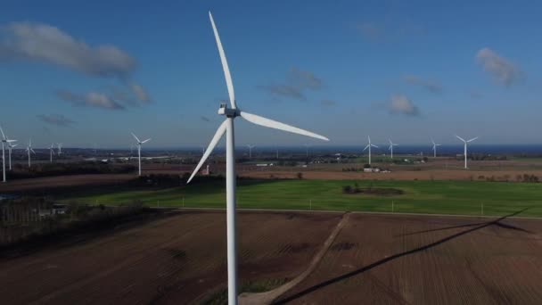 Wind Turbine Generating Power While Casting Shadow Surrounded Wind Turbines — Stock Video