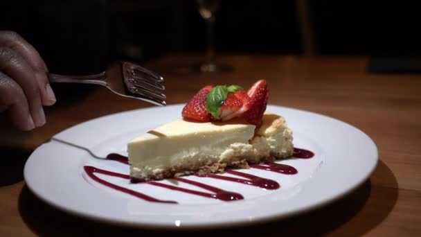Taking First Bite Mouthwatering Slice Decadent Cheesecake Topped Fresh Strawberries — Stock Video